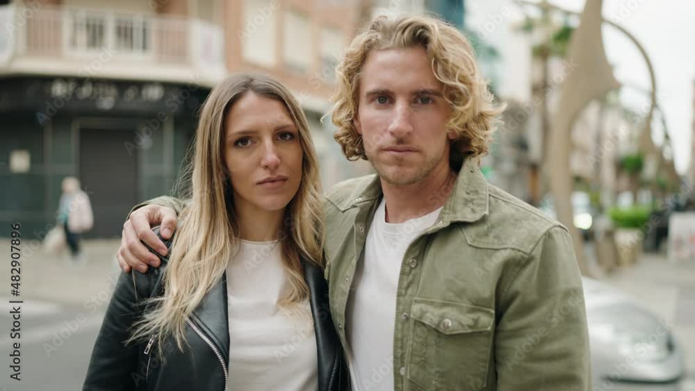 Young caucasian couple smiling confident hugging each other standing at street Young caucasian couple smiling confident hugging each other standing at street