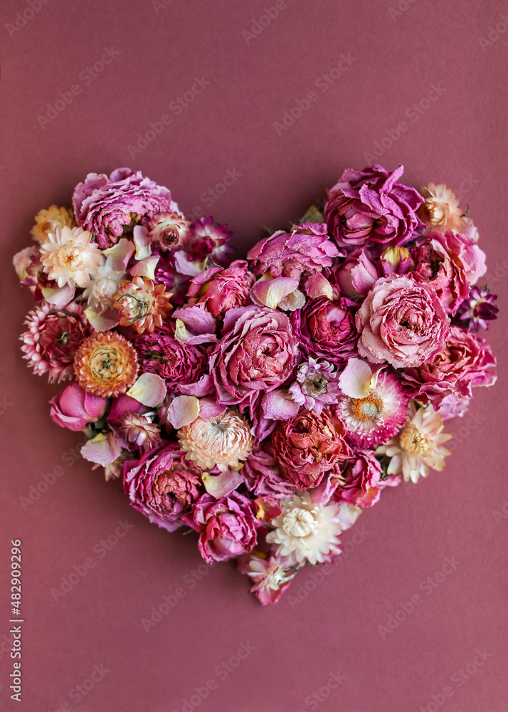 Valentine's Day card. Heart of dry buds of peony roses and helichrysum flowers in shades of pink Valentine's Day card. Heart of dry buds of peony roses and helichrysum flowers in shades of pink