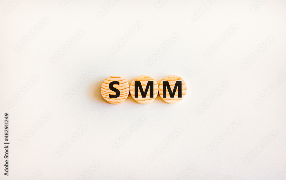 SMM, social media marketing symbol. Concept word SMM social media marketing on wooden circles on beautiful white background, copy space. Business, SMM social media marketing concept. SMM, social media marketing symbol. Concept word SMM social media marketing on wooden circles on beautiful white background, copy space. Business, SMM social media marketing concept.