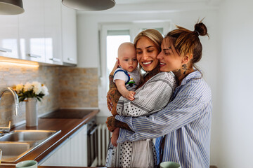 Two lesbian women with a baby boy at home