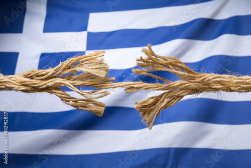 Frayed rope against Greek flag as a national crisis concept photo