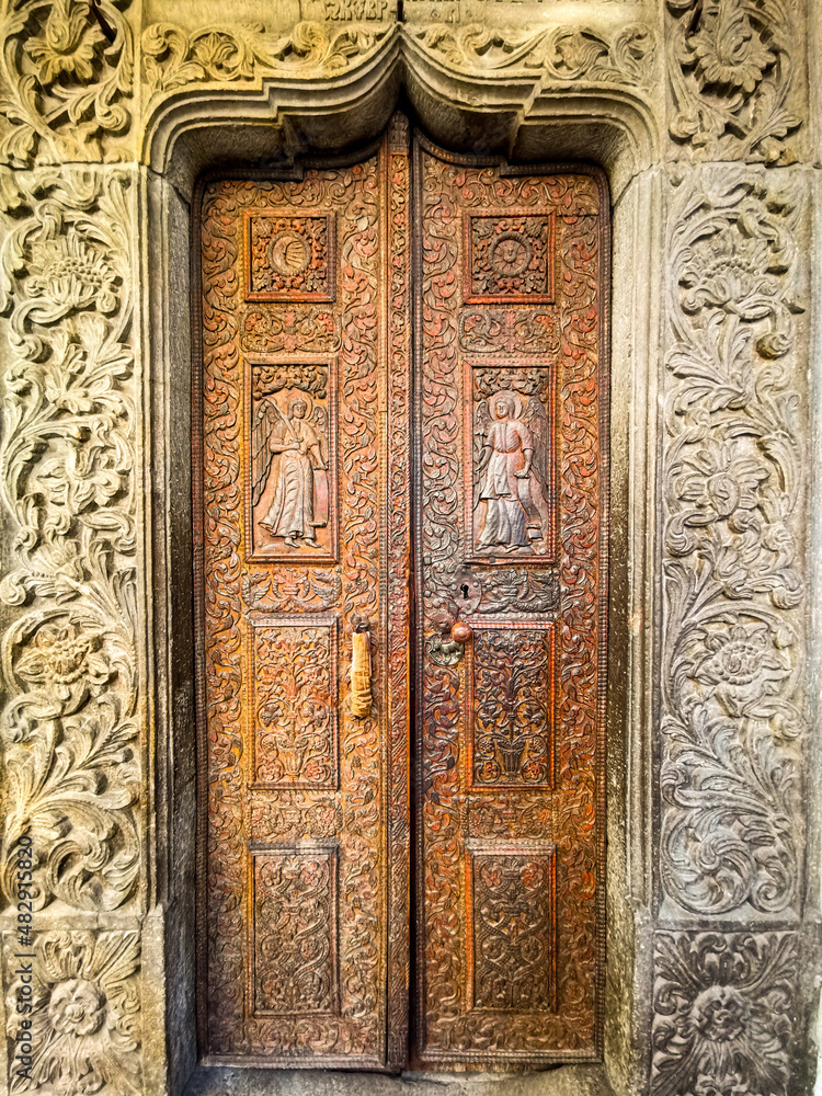 Old wooden door of a orthodox church in Bucharest, Romania.