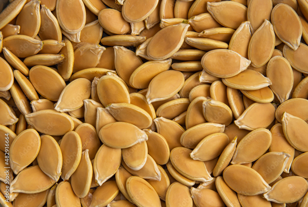 unpeeled pumpkin seeds piled in a pile