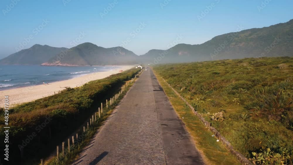 Aerial view of Grumari Beach, a paradise in the west side of Rio de Janeiro, Brazil. Big hills around. Sunny day at dawn. Drone take. Aerial view of Grumari Beach, a paradise in the west side of Rio de Janeiro, Brazil. Big hills around. Sunny day at dawn. Drone take.