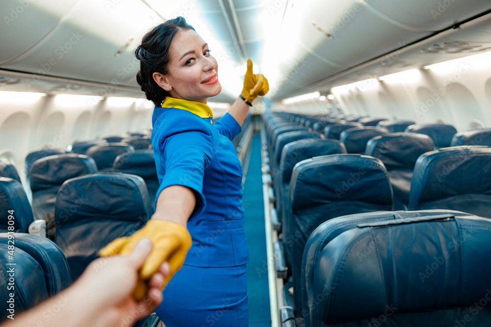 Why do flight attendants sit on their hands?