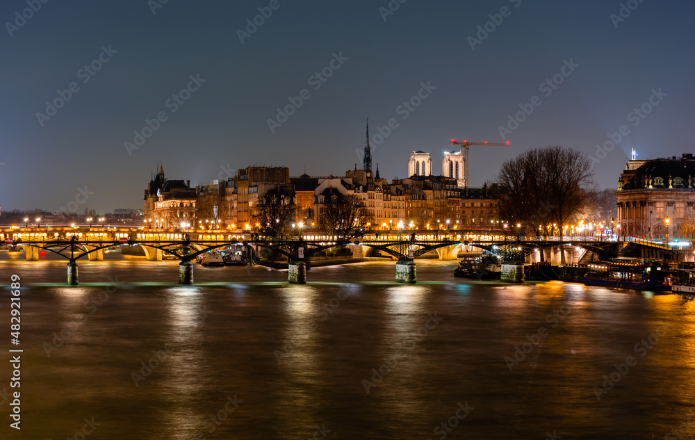 Night Paris, reflection of lights in the river Seine, cityscape