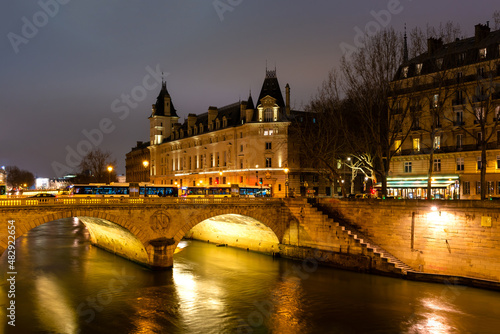 Night Paris, Pont au Change, reflection of lights in the river Seine, cityscape photo