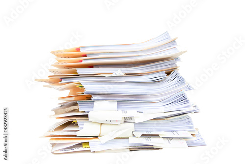Manila folders stacked overflowing an in box at an office on a white background