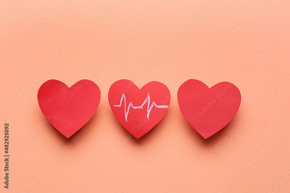 Red hearts and cardiogram drawing on color background. Donation concept