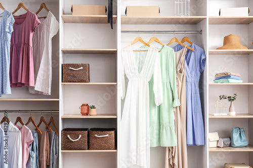 Interior of walk-in closet with trendy clothes
