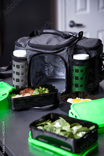 Green Tupperware food containers with meal prep food inside