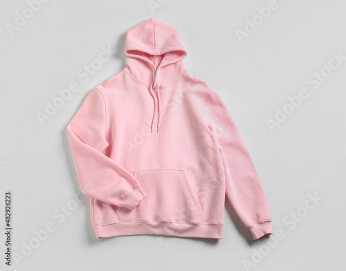 Stylish pink hoodie on white background