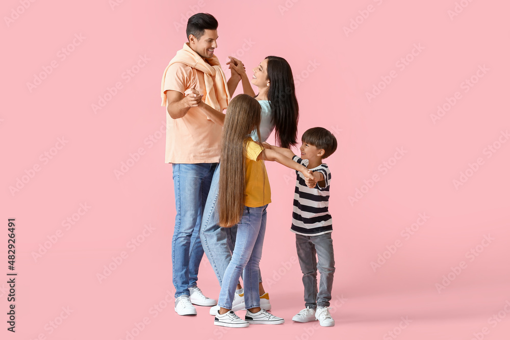 Happy dancing family on color background