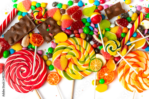 colorful candies, lollipops and chocolates on a white background