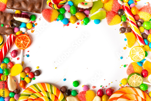 An assortment of colourful, festive sweets, ice-cream and candy in a panoramic orientation.