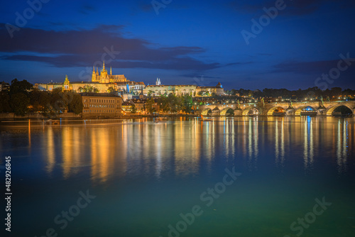Wide angle view of the Prague Castle with the bridge reflection at blue hour
