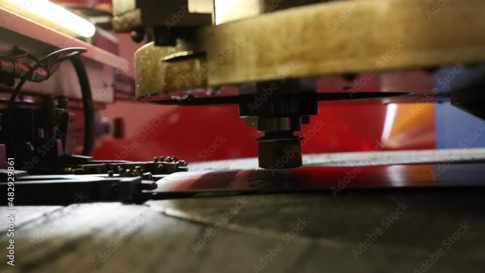 stamp machine that makes holes in a metal sheet in a factory stamp machine that makes holes in a metal sheet in a factory