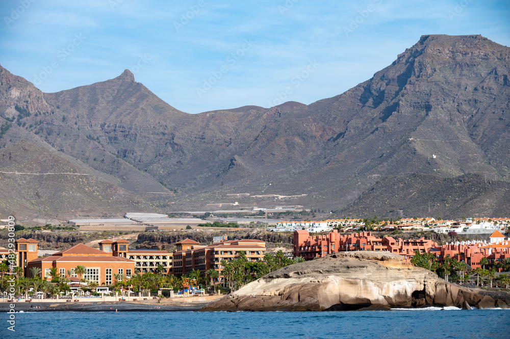 Obraz premium View on resorts and beaches of South coast of Tenerife island during sail boat trip along coastline, Canary islands, Spain
