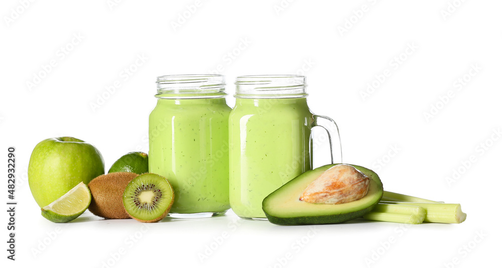 Mason jars of healthy green juice and fresh fruits on white background Mason jars of healthy green juice and fresh fruits on white background