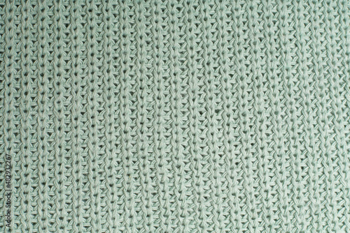 Knitted woolen sweater as background, closeup