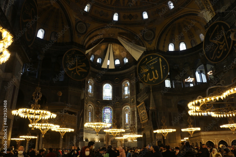 selective focus.  istanbul: local and foreign tourists visiting the historical Hagia Sophia mosque with its magnificent architecture visit the mosque and pray.