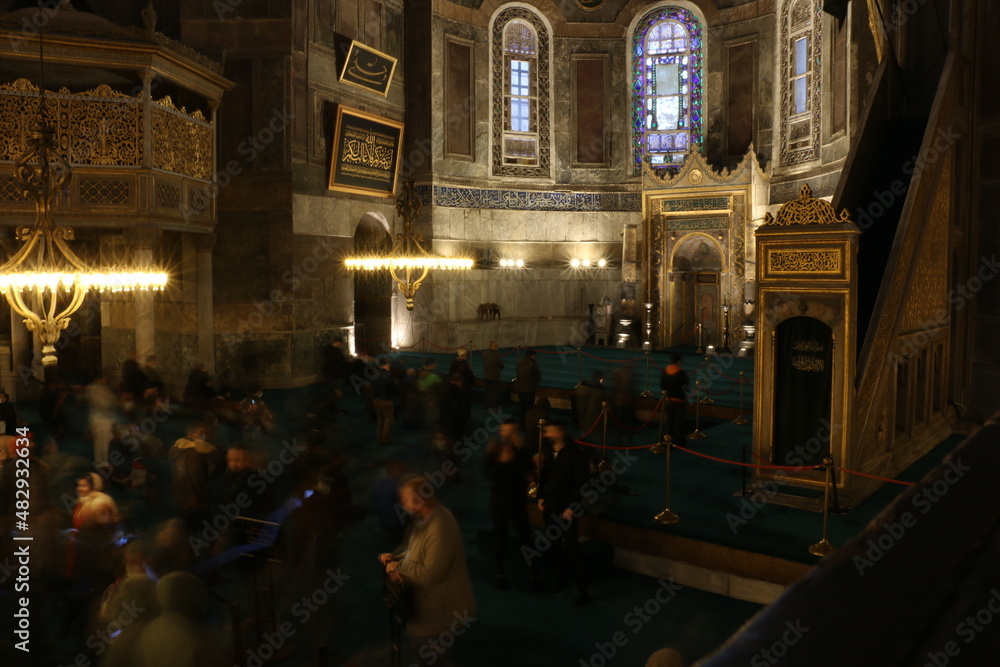 selective focus.  istanbul: local and foreign tourists visiting the historical Hagia Sophia mosque with its magnificent architecture visit the mosque and pray.