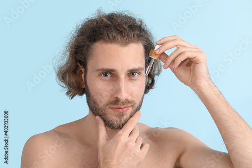 Young man with serum for sk...