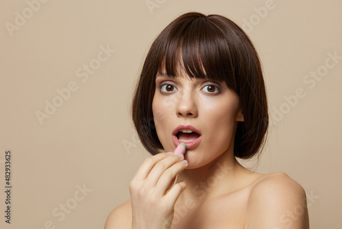 portrait woman smile lip makeup charm short haircut beige background
