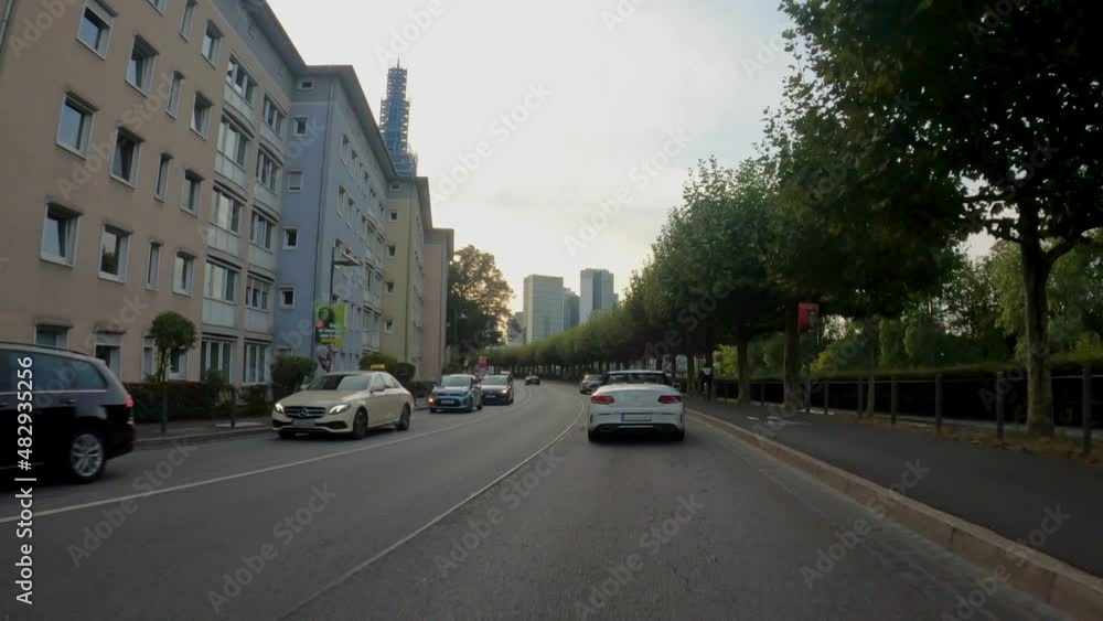 Moving shot of cars driving on Frankfurt city center streets, at sunset Moving shot of cars driving on Frankfurt city center streets, at sunset