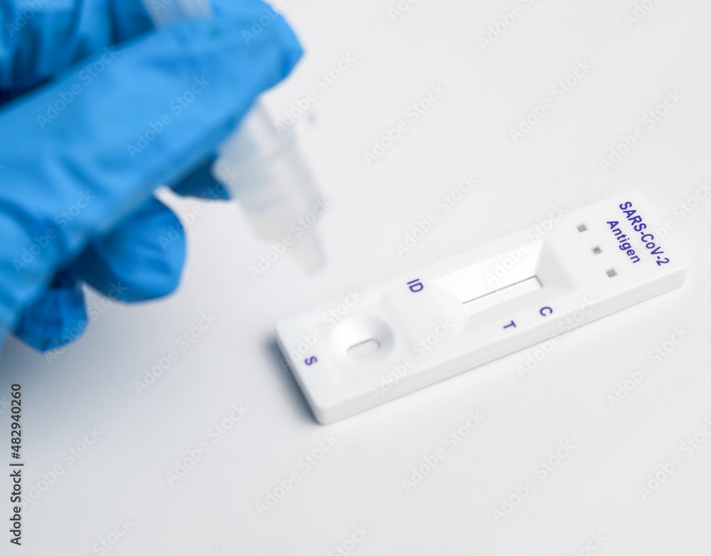 Man makes a covid-19 antigen pcr test macro. The test showed a positive result. Man makes a covid-19 antigen pcr test macro. The test showed a positive result.