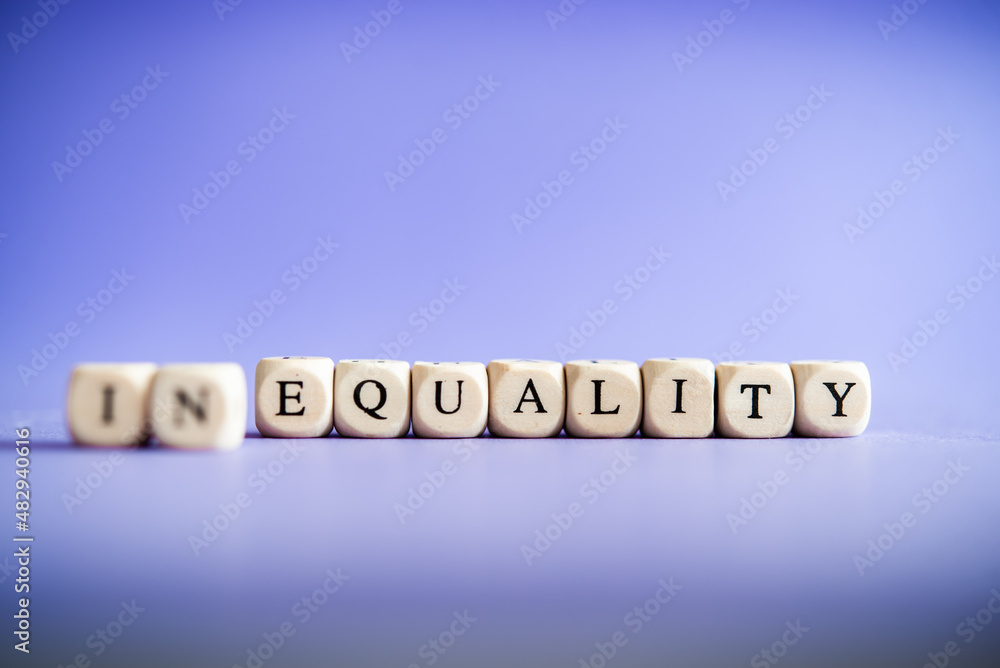 Equality between men and women, gender equality, non-discrimination. Word of equality and non-equality on a purple background. Feminism Equality between men and women, gender equality, non-discrimination. Word of equality and non-equality on a purple background. Feminism