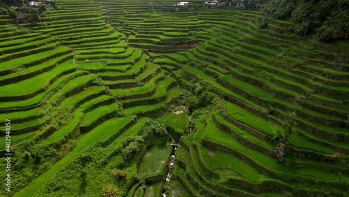 Aerial tilt up shot showing the ancient Ifugao Rice Terraces at Batad in northern Luzon, Philippines. photo