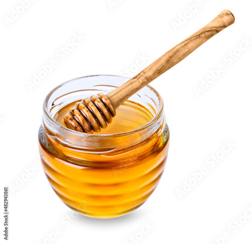 Glass jar with honey and wooden honey dipper isolated on white background