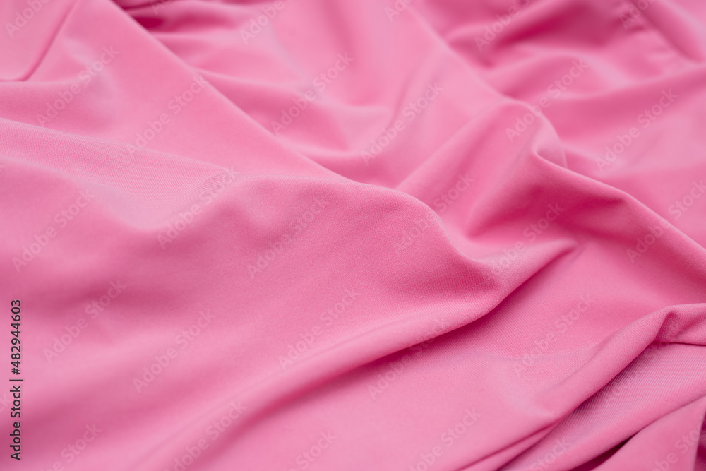 Soft focus texture of the silk fabric, soft pink. Peach pink fabric background. Crumpled soft rose color satin texture Pastel textile background. Soft focus texture of the silk fabric, soft pink. Peach pink fabric background. Crumpled soft rose color satin texture Pastel textile background.