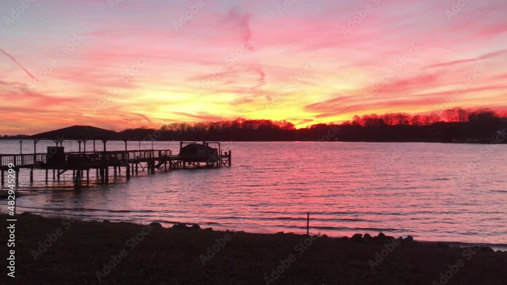 Gorgeous sunset on a wide open lake with silhouetted pier
Gorgeous sunset on a wide open lake with silhouetted pier
