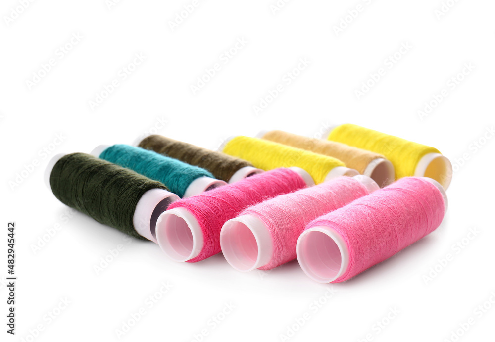 Different sewing thread spools on white background Different sewing thread spools on white background