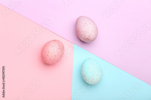 Three Easter eggs on color background