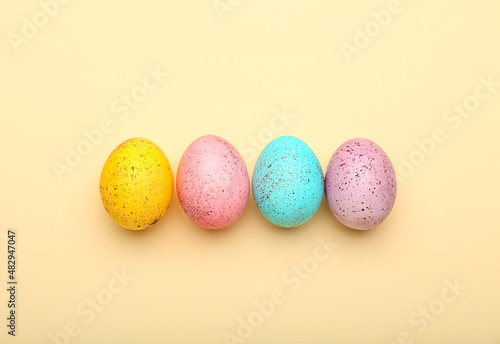Beautiful painted Easter eggs on color background