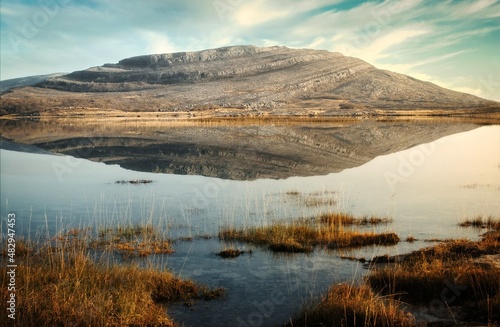 Beautiful morning landscape scenery with mountains reflected in Lake at Burren National Park in county Galway, Ireland 