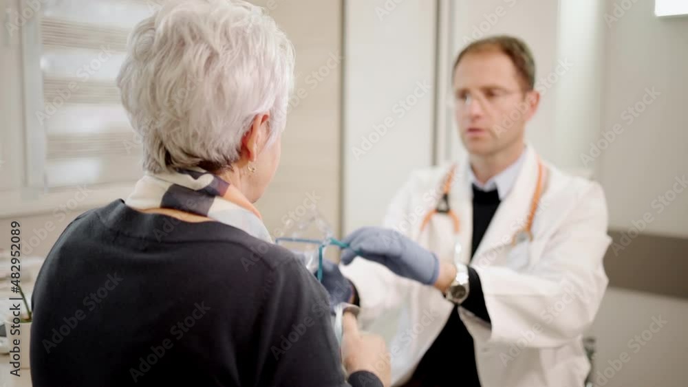 Doctor specialist having a session with patient. Senior lady at clinic checking her health. Medic measures a blood pressure and temperature. Seasoned female person getting a vaccine. Doctor specialist having a session with patient. Senior lady at clinic checking her health. Medic measures a blood pressure and temperature. Seasoned female person getting a vaccine.