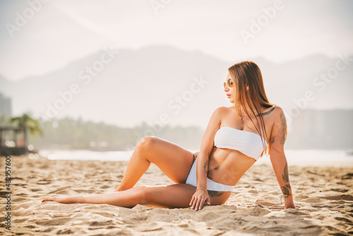 woman modeling a white bikini on the beach 
