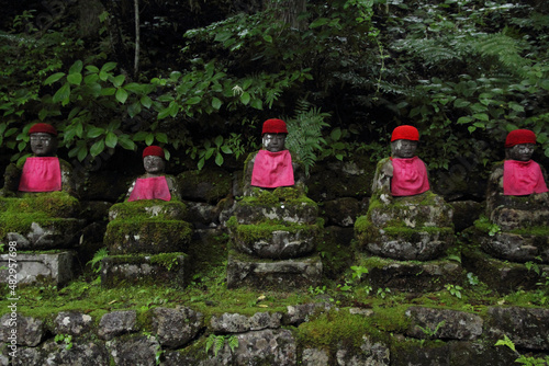 Row of buddhist jizo statues in Nikko, Japan photo