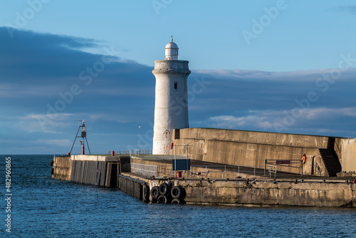 BUCKIE,MORAY, SCOTLAND - 23 JANUARY 2022: This is the sun shining on the entrance to the harbour at Buckie, Moray, Scotland on 23 January 2022.