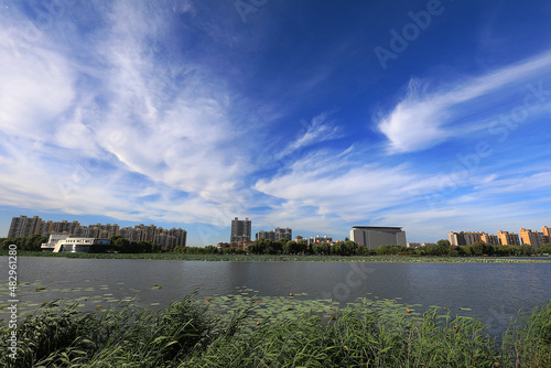 Beautiful waterfront city scenery under blue sky and white clouds, North China
