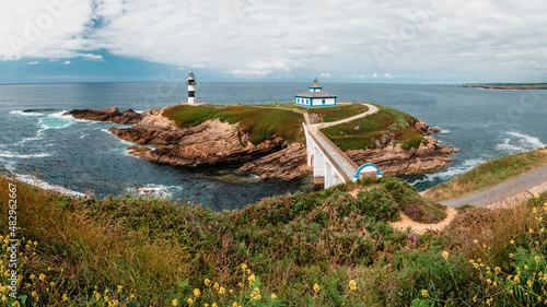Lighthouse on an island off the coast photo
