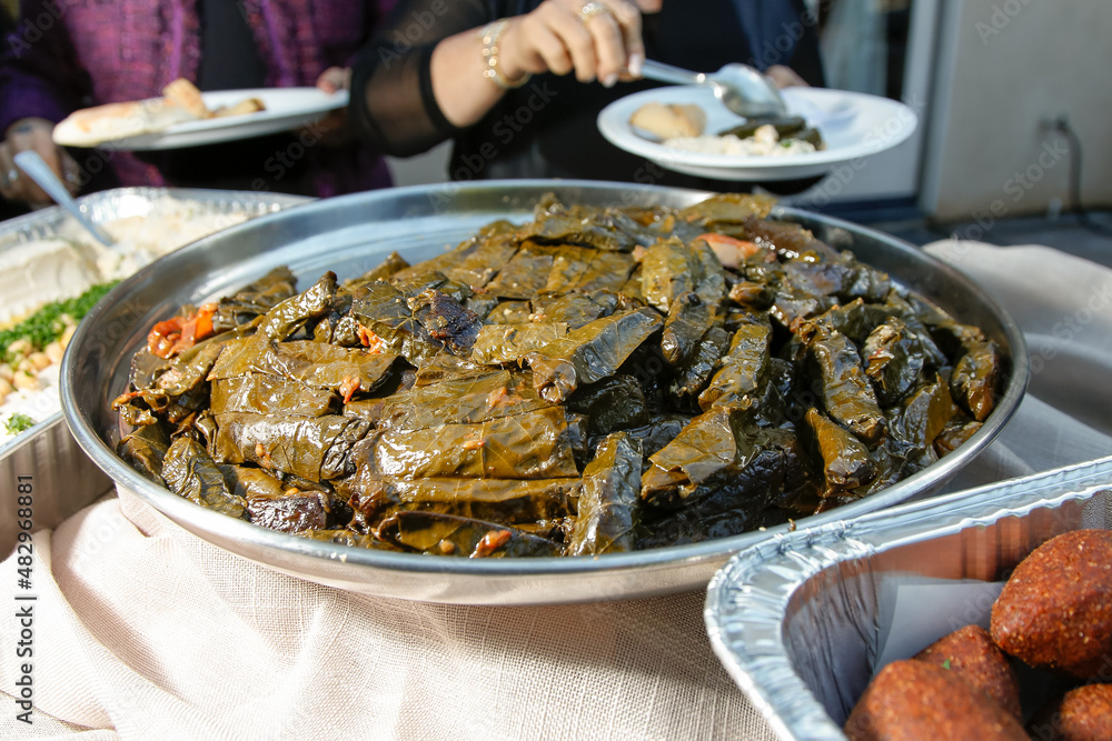 A view a catering platter of stuffed grape leaves. A view a catering platter of stuffed grape leaves.