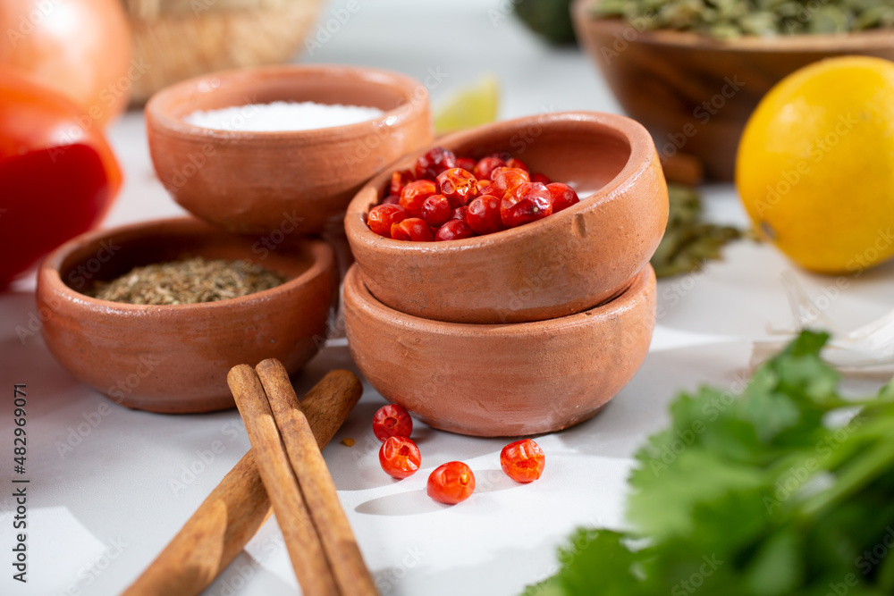A view of a clay condiment cup full of tepin chiles, among other Mexican ingredients. A view of a clay condiment cup full of tepin chiles, among other Mexican ingredients.