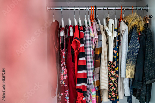 Female childish wardrobe apparel hanged comfortable vertical storage Marie Kondo minimalist method photo