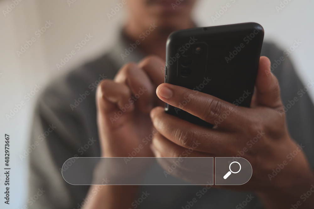 A young man is using a smartphone to search for information on the Internet. A young man is using a smartphone to search for information on the Internet.
