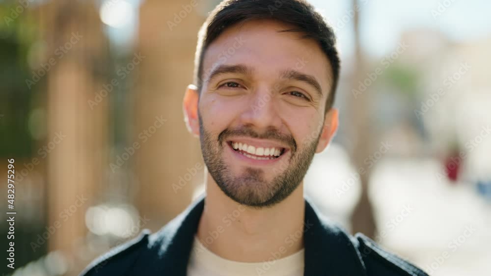 Young hispanic man smiling confident standing at street Young hispanic man smiling confident standing at street